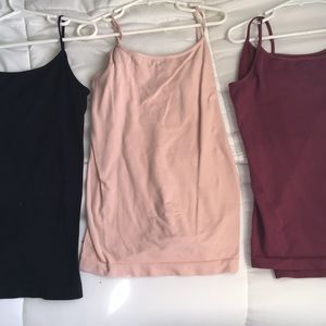 Black, maroon, and light pink tank tops.